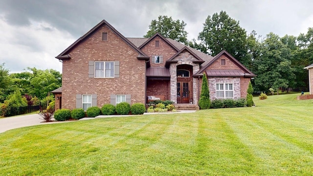 115 Eston Way, Mount Juliet, TN 37122 - view of front of house featuring a front yard, a standing seam roof, and brick siding