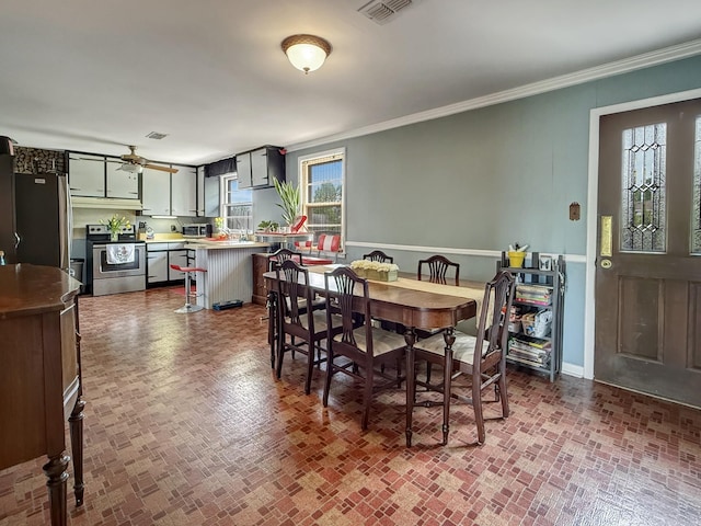 3113 Stafford Dr, Nashville, TN 37214 - dining area with brick patterned floors, crown molding, ceiling fan, and baseboards