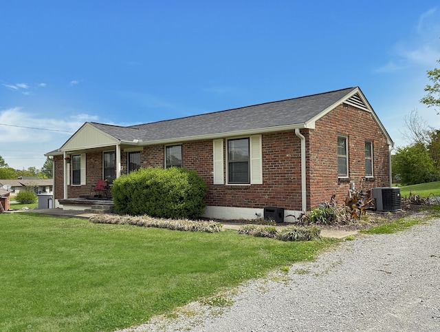3113 Stafford Dr, Nashville, TN 37214 - view of front facade with central air condition unit, brick siding, a front yard, and roof with shingles
