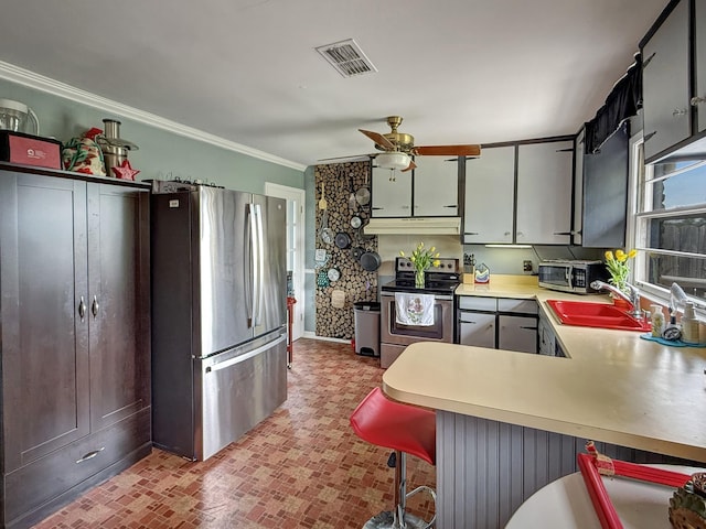 3113 Stafford Dr, Nashville, TN 37214 - kitchen with stainless steel appliances, a sink, under cabinet range hood, brick patterned flooring, and crown molding