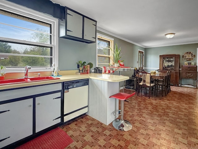 3113 Stafford Dr, Nashville, TN 37214 - kitchen with white dishwasher, a sink, crown molding, a peninsula, and light countertops