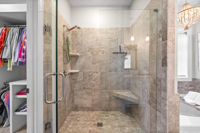 982 Red Bluff Way, Adams, TN 37010 - full bathroom featuring a spacious closet, a shower stall, and a chandelier