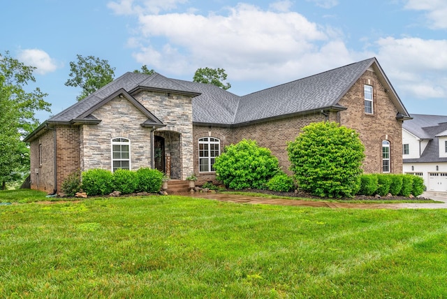 982 Red Bluff Way, Adams, TN 37010 - view of front of home featuring a front lawn, brick siding, a shingled roof, and stone siding