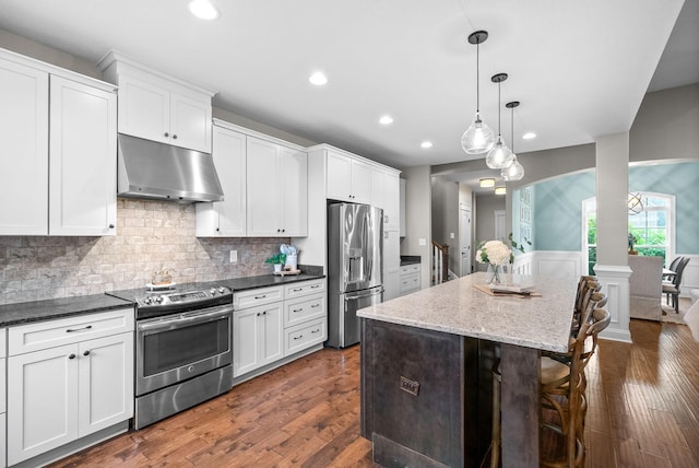 982 Red Bluff Way, Adams, TN 37010 - kitchen featuring stainless steel appliances, under cabinet range hood, recessed lighting, a kitchen bar, and a kitchen island