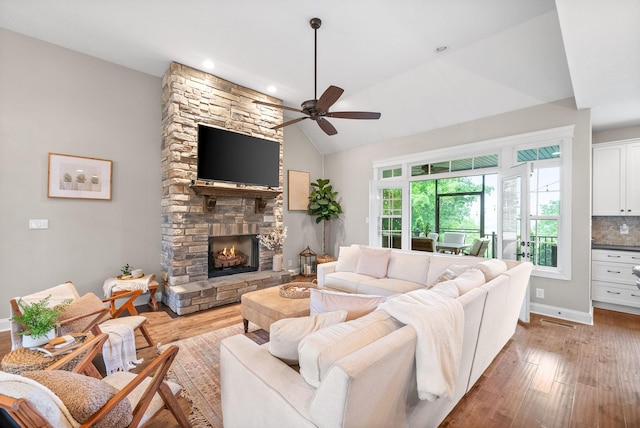 982 Red Bluff Way, Adams, TN 37010 - living area with ceiling fan, light wood finished floors, a fireplace, baseboards, and high vaulted ceiling