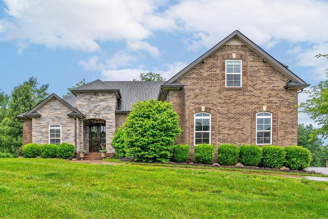 982 Red Bluff Way, Adams, TN 37010 - view of front of home with a front lawn, brick siding, and a shingled roof