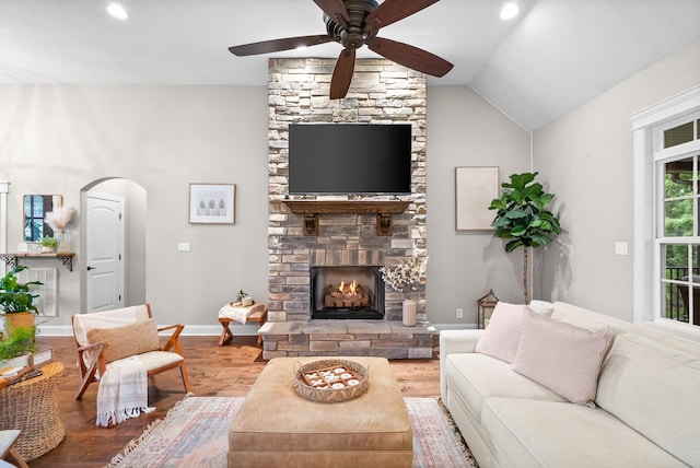 982 Red Bluff Way, Adams, TN 37010 - living area featuring a stone fireplace, a ceiling fan, wood finished floors, baseboards, and lofted ceiling