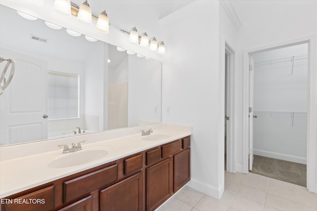 241 Hillside Ln, Lenoir City, TN 37771 - bathroom with double vanity, tile patterned floors, a walk in closet, and baseboards