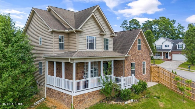 241 Hillside Ln, Lenoir City, TN 37771 - view of side of home with a shingled roof, covered porch, stone siding, and a garage