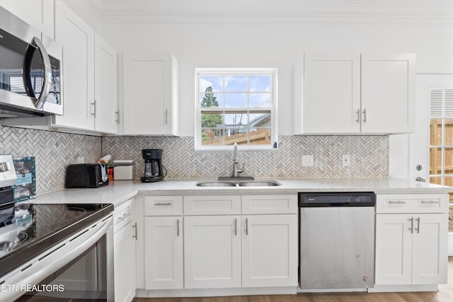 241 Hillside Ln, Lenoir City, TN 37771 - kitchen featuring stainless steel appliances, a sink, white cabinetry, ornamental molding, and tasteful backsplash