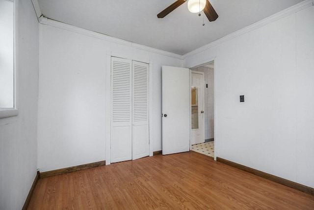 852 Eastland Rd, Sparta, TN 38583 - unfurnished bedroom with wood finished floors, crown molding, baseboards, a ceiling fan, and a closet