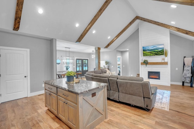 1270 Post Oak Rd, Belvidere, TN 37306 - kitchen with a center island, a fireplace, light wood-type flooring, baseboards, and beamed ceiling