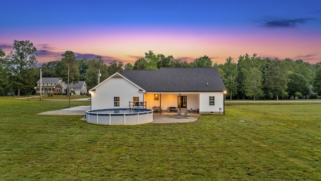 1270 Post Oak Rd, Belvidere, TN 37306 - back of house at dusk with an outdoor pool, a patio area, a yard, and crawl space