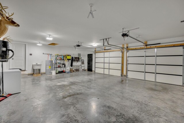 1270 Post Oak Rd, Belvidere, TN 37306 - garage with water heater, a garage door opener, and a sink