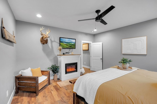 1270 Post Oak Rd, Belvidere, TN 37306 - bedroom featuring recessed lighting, a glass covered fireplace, light wood-style flooring, baseboards, and a ceiling fan
