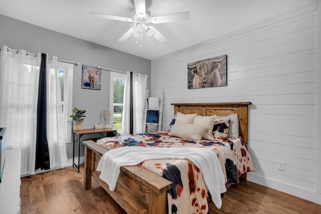 1270 Post Oak Rd, Belvidere, TN 37306 - bedroom with wood finished floors, baseboards, ceiling fan, and wooden walls