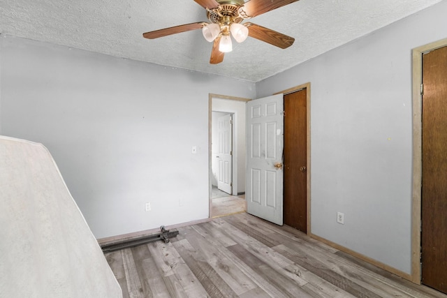 210 Welch Rd, Tazewell, TN 37879 - unfurnished bedroom featuring a textured ceiling, wood finished floors, baseboards, and a ceiling fan