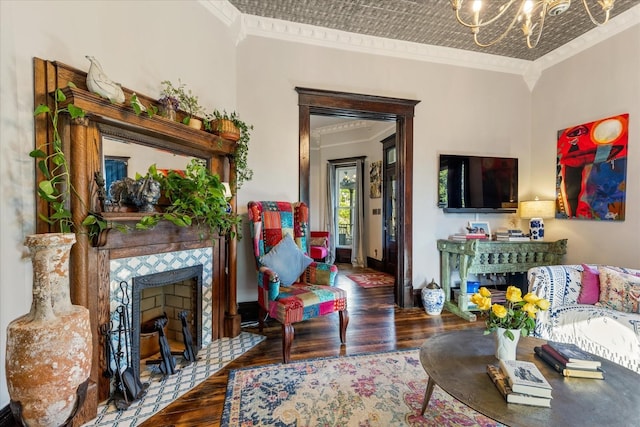 207 Main St E, Wartrace, TN 37183 - living room with ornamental molding, wood finished floors, a chandelier, a tile fireplace, and baseboards