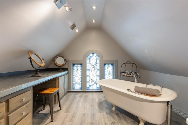 207 Main St E, Wartrace, TN 37183 - bathroom featuring a freestanding bath, vaulted ceiling, wood finished floors, and recessed lighting