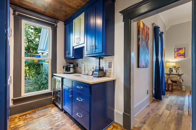 207 Main St E, Wartrace, TN 37183 - bar featuring wine cooler, light wood finished floors, a sink, tasteful backsplash, and baseboards