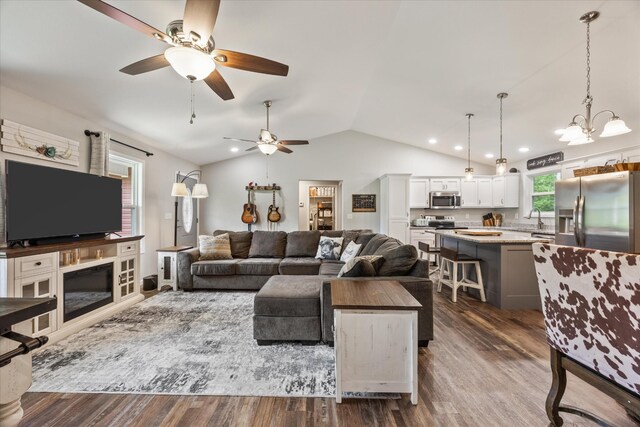 439 Ferry Bend Trl, Crossville, TN 38571 - living room featuring a ceiling fan, vaulted ceiling, dark wood finished floors, and a chandelier