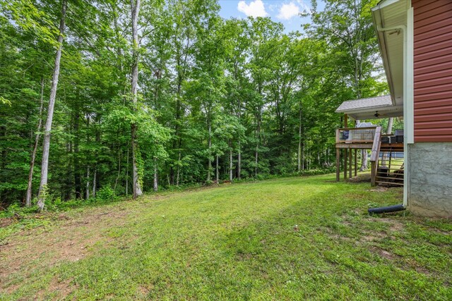 439 Ferry Bend Trl, Crossville, TN 38571 - view of green lawn featuring stairs, a wooden deck, and a wooded view