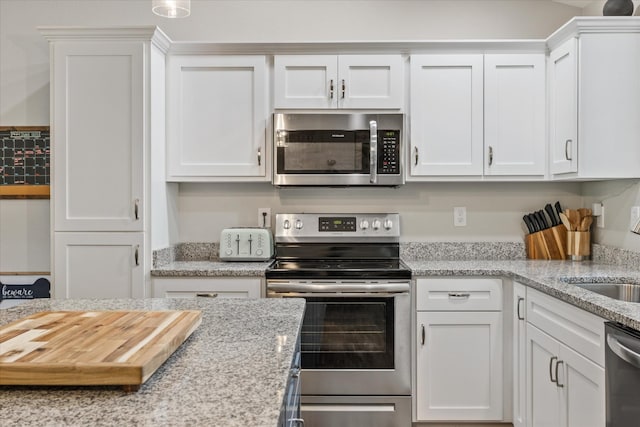 439 Ferry Bend Trl, Crossville, TN 38571 - kitchen with appliances with stainless steel finishes, white cabinetry, light stone countertops, and a sink