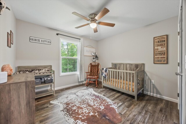 439 Ferry Bend Trl, Crossville, TN 38571 - bedroom featuring wood finished floors, baseboards, a nursery area, and ceiling fan