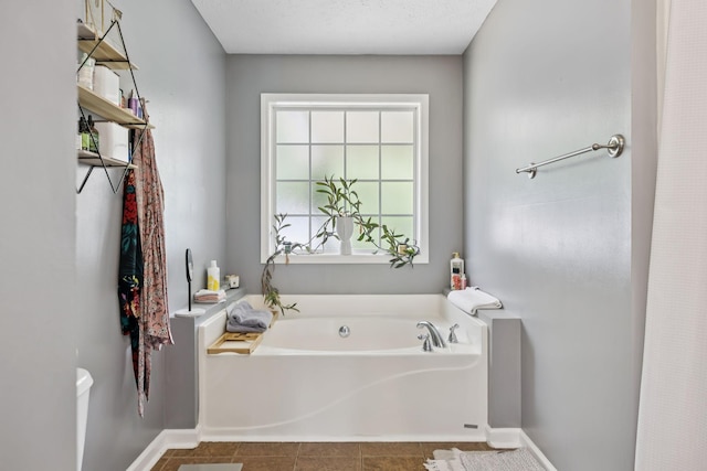 123 Hubbard St, Hohenwald, TN 38462 - full bathroom featuring a garden tub, toilet, tile patterned flooring, and baseboards