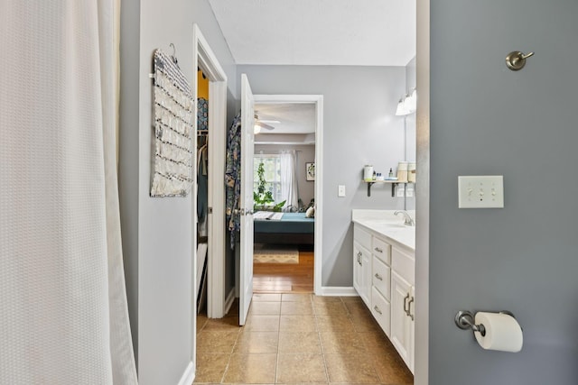123 Hubbard St, Hohenwald, TN 38462 - full bathroom with double vanity, connected bathroom, tile patterned flooring, ceiling fan, and baseboards