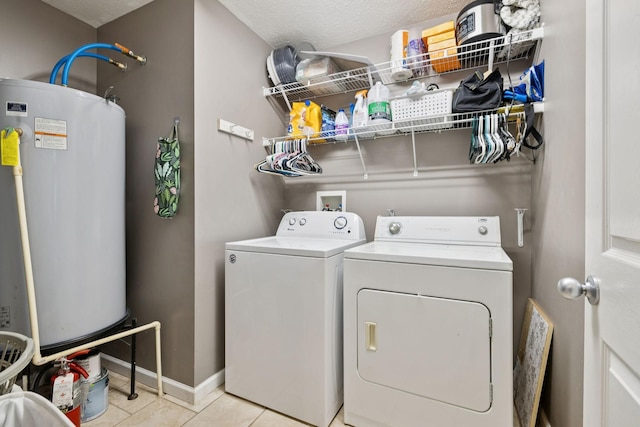 123 Hubbard St, Hohenwald, TN 38462 - laundry area with washer and dryer, water heater, baseboards, and light tile patterned floors