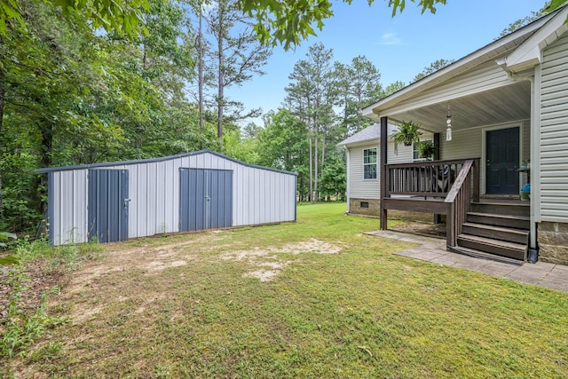 123 Hubbard St, Hohenwald, TN 38462 - view of grassy yard featuring an outbuilding and a deck