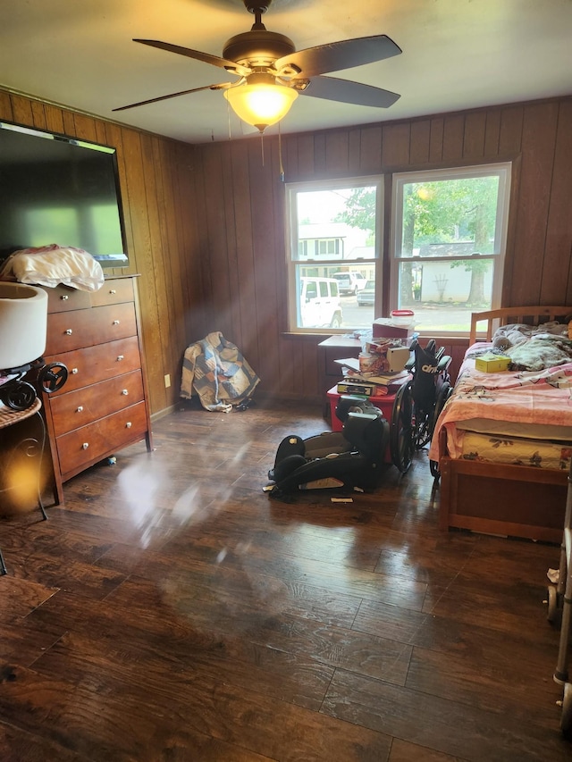 303 Shady Ln, Lawrenceburg, TN 38464 - bedroom with dark wood finished floors, multiple windows, wooden walls, and ceiling fan