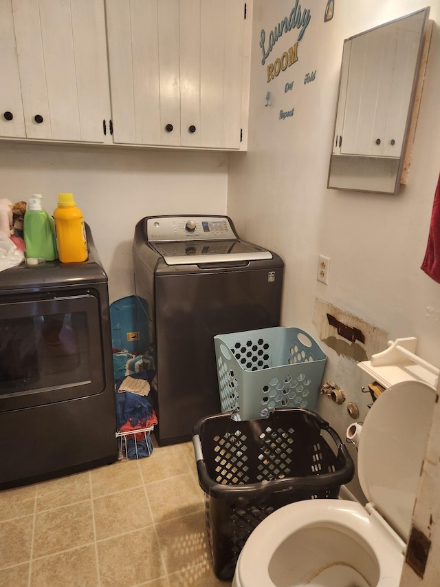 303 Shady Ln, Lawrenceburg, TN 38464 - laundry room with independent washer and dryer, cabinet space, and tile patterned flooring