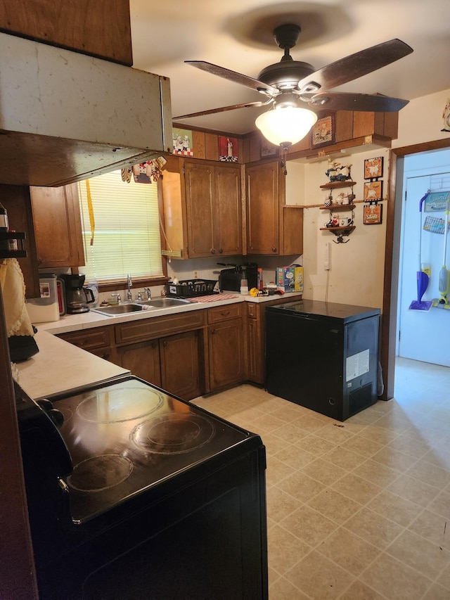 303 Shady Ln, Lawrenceburg, TN 38464 - kitchen featuring black / electric stove, a sink, ceiling fan, light countertops, and brown cabinetry