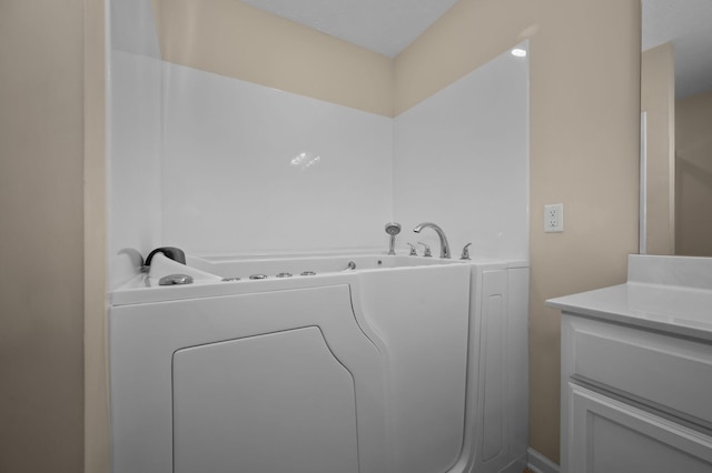 4713 Pompano Ln, Murfreesboro, TN 37128 - bathroom featuring washer / dryer, a garden tub, and vanity
