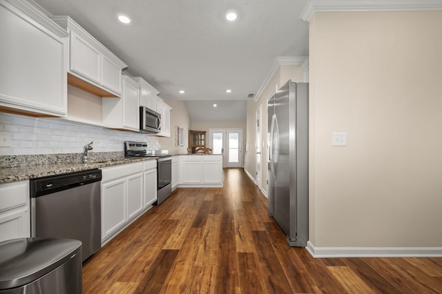 4713 Pompano Ln, Murfreesboro, TN 37128 - kitchen featuring appliances with stainless steel finishes, white cabinetry, tasteful backsplash, light stone countertops, and crown molding