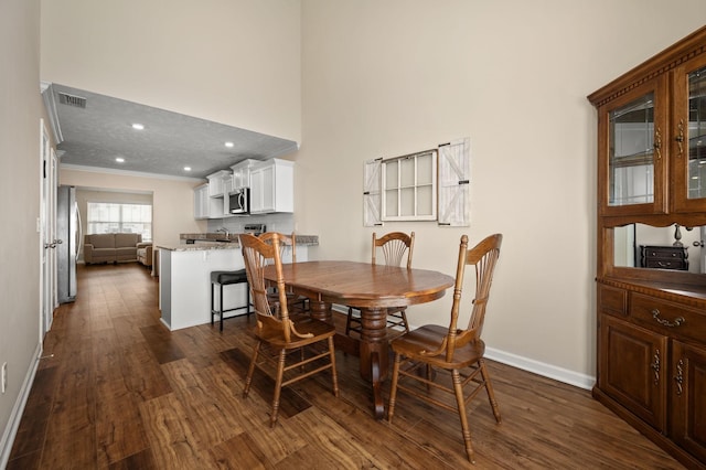 4713 Pompano Ln, Murfreesboro, TN 37128 - dining room with dark wood-style floors, ornamental molding, a high ceiling, and recessed lighting