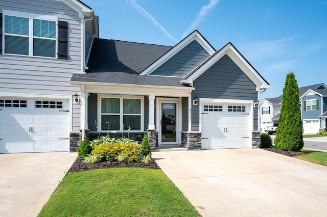 4713 Pompano Ln, Murfreesboro, TN 37128 - craftsman house with driveway, stone siding, a shingled roof, and an attached garage