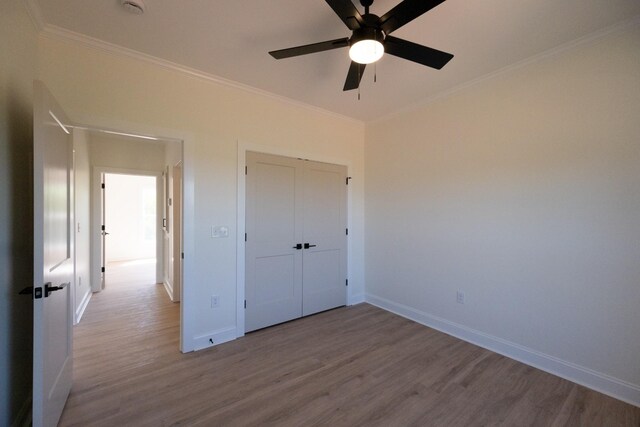 10 Henkle Dr, Loretto, TN 38469 - unfurnished bedroom featuring wood finished floors, ornamental molding, baseboards, a closet, and a ceiling fan