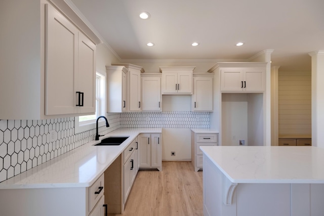 10 Henkle Dr, Loretto, TN 38469 - kitchen featuring a sink, white cabinets, crown molding, backsplash, and recessed lighting