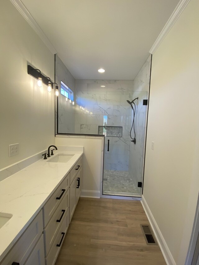 10 Henkle Dr, Loretto, TN 38469 - full bath featuring double vanity, a marble finish shower, wood finished floors, ornamental molding, and baseboards