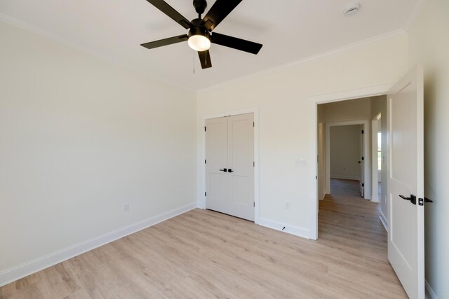10 Henkle Dr, Loretto, TN 38469 - unfurnished bedroom with crown molding, light wood-type flooring, baseboards, a closet, and a ceiling fan