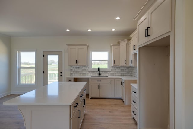10 Henkle Dr, Loretto, TN 38469 - kitchen featuring a sink, decorative backsplash, a center island, light wood-style flooring, and recessed lighting