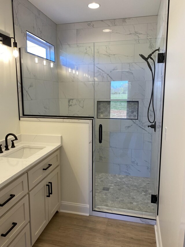 10 Henkle Dr, Loretto, TN 38469 - bathroom featuring vanity, a marble finish shower, wood finished floors, baseboards, and recessed lighting