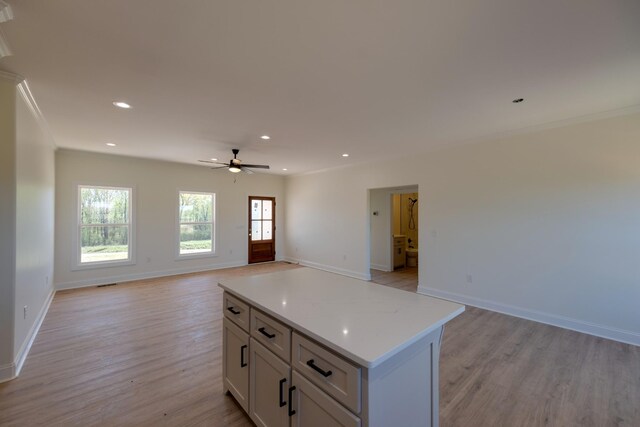 10 Henkle Dr, Loretto, TN 38469 - kitchen featuring open floor plan, light wood-type flooring, light countertops, recessed lighting, and crown molding