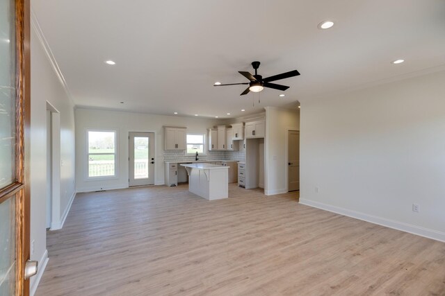 10 Henkle Dr, Loretto, TN 38469 - kitchen with open floor plan, plenty of natural light, a center island, decorative backsplash, and recessed lighting