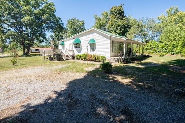 5116 Jim Cummings Hwy, Woodbury, TN 37190 - view of home's exterior featuring a lawn and a wooden deck