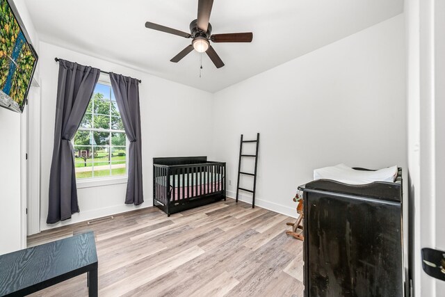 425 Royal Dr, Rock Island, TN 38581 - bedroom featuring light wood-style floors, baseboards, ceiling fan, and a nursery area