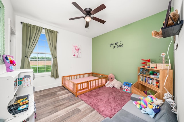 425 Royal Dr, Rock Island, TN 38581 - bedroom featuring wood finished floors, a nursery area, ceiling fan, and baseboards